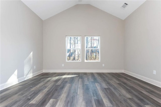 unfurnished room featuring lofted ceiling and dark wood-type flooring