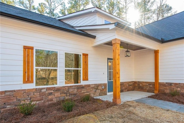 view of exterior entry with a patio area