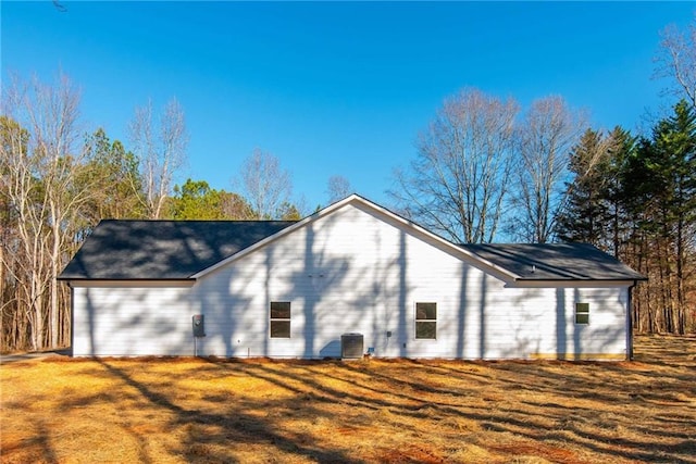 rear view of house with a yard and central air condition unit