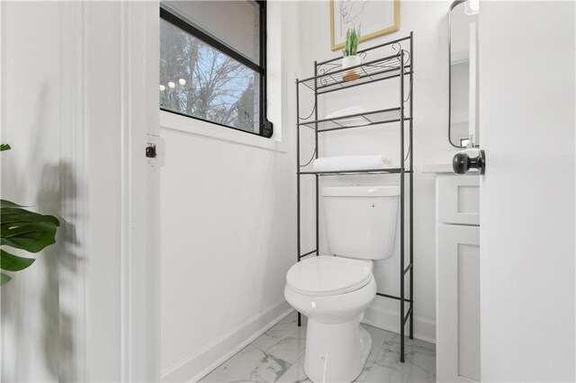 1066 Cleavemark Dr, Clarkston, GA 30021 - bathroom featuring toilet, baseboards, and marble look tiles