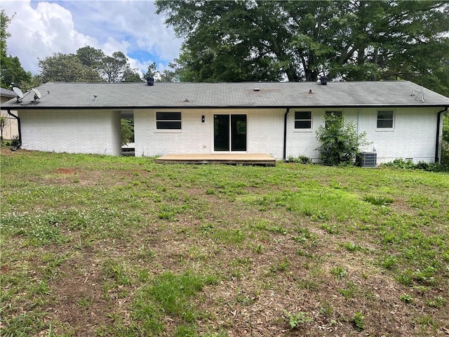 1066 Cleavemark Dr, Clarkston, GA 30021 - back of property with brick siding, a deck, a lawn, and central AC unit
