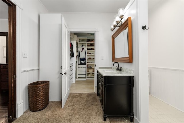 161 N Barton St, Norcross, GA 30071 - bathroom with vanity, a wainscoted wall, a walk in closet, and ornamental molding