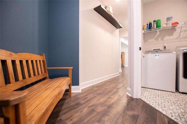 clothes washing area featuring dark hardwood / wood-style flooring and washing machine and clothes dryer