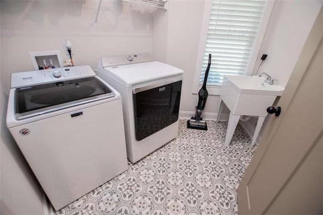 clothes washing area featuring washer and clothes dryer