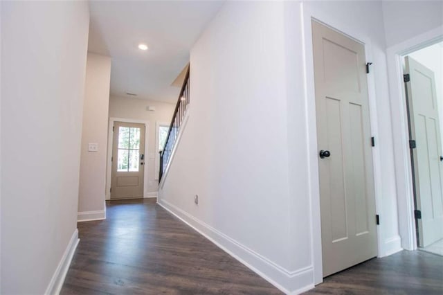 corridor with dark hardwood / wood-style flooring