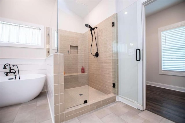 bathroom featuring lofted ceiling, a healthy amount of sunlight, separate shower and tub, and tile patterned floors