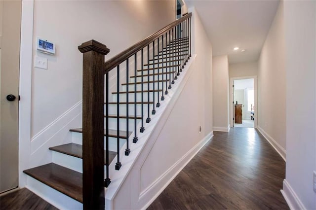 staircase with wood-type flooring