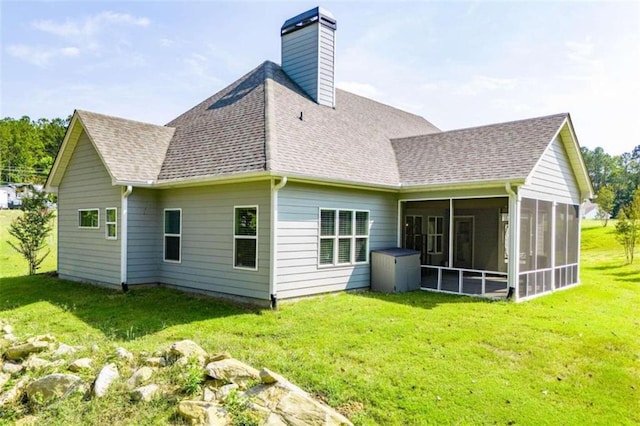 back of property featuring a lawn and a sunroom