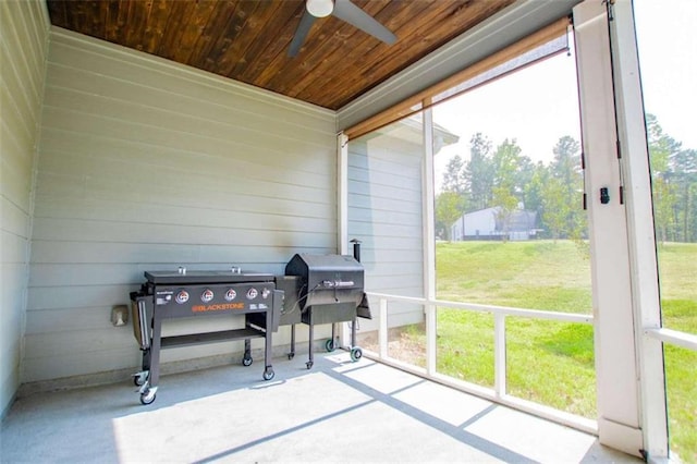 sunroom featuring wood ceiling and ceiling fan