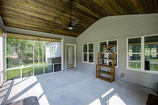 unfurnished sunroom featuring ceiling fan and vaulted ceiling