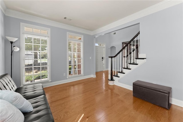 foyer entrance featuring wood-type flooring and ornamental molding