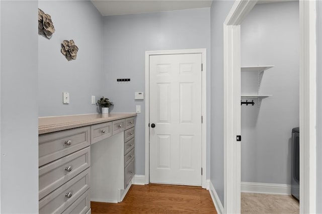 interior space featuring wood-type flooring and washer / clothes dryer