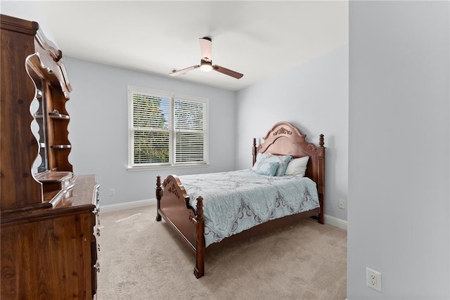 bedroom featuring ceiling fan and light carpet