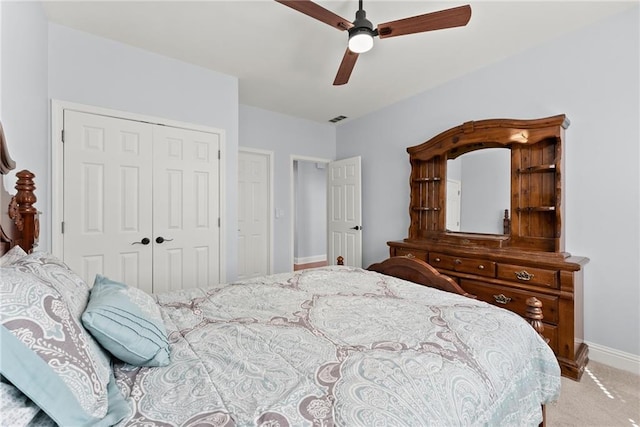 bedroom with ceiling fan, a closet, and light colored carpet