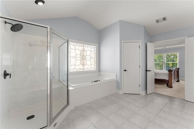 bathroom with tile patterned floors, independent shower and bath, and vaulted ceiling