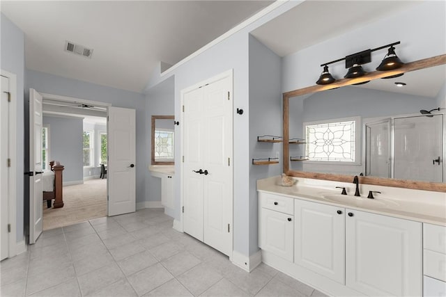 bathroom with tile patterned floors, vanity, an enclosed shower, and lofted ceiling