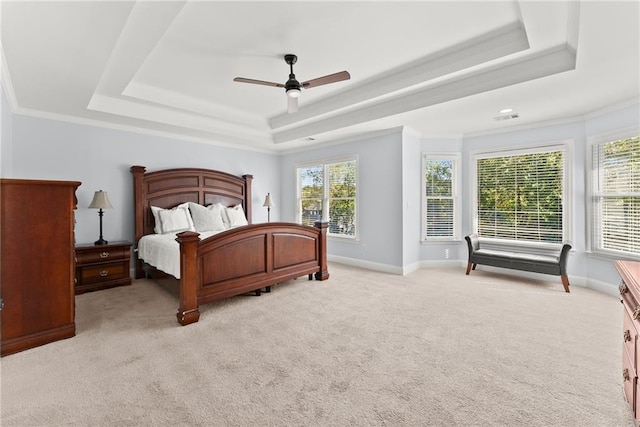 bedroom featuring light carpet, a raised ceiling, ceiling fan, and ornamental molding