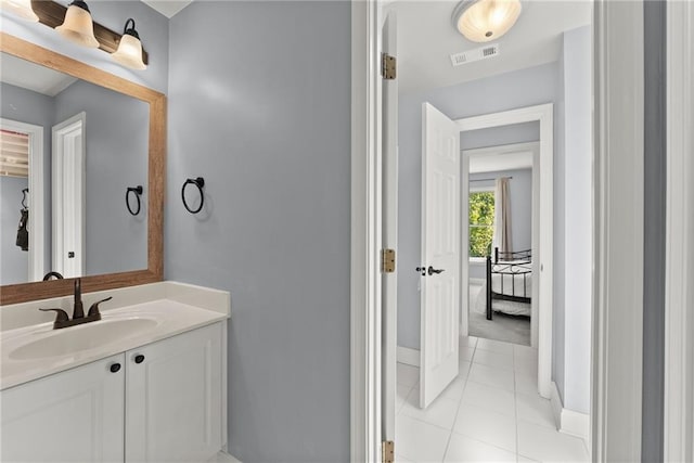 bathroom with tile patterned flooring and vanity