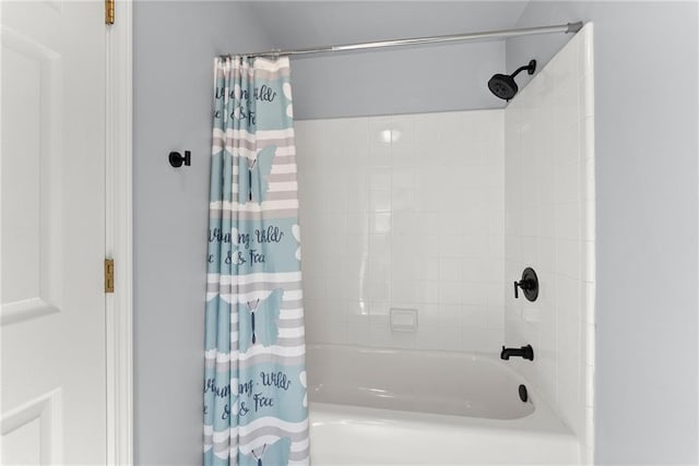 bathroom with shower / bathtub combination with curtain