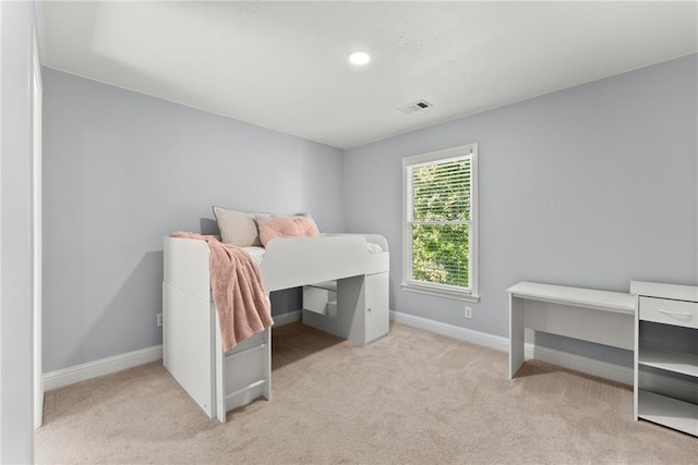 bedroom featuring light colored carpet