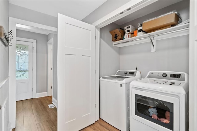2545 Hickory Level Rd, Villa Rica, GA 30180 - laundry area with washing machine and clothes dryer and light wood-style floors