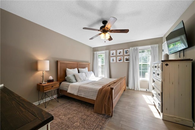 71 Headland Ct, Rockmart, GA 30153 - bedroom with wood finished floors, a textured ceiling, a ceiling fan, and baseboards