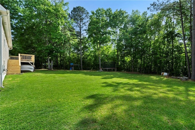 71 Headland Ct, Rockmart, GA 30153 - view of green lawn with a playground, a trampoline, and a wooden deck