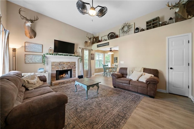 71 Headland Ct, Rockmart, GA 30153 - living room featuring a ceiling fan, wood finished floors, a stone fireplace, and baseboards