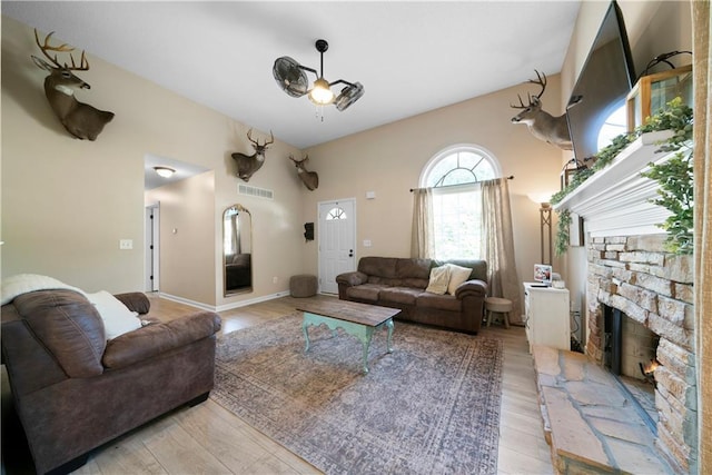 71 Headland Ct, Rockmart, GA 30153 - living room featuring light wood finished floors and a stone fireplace