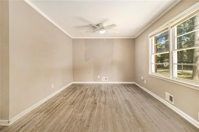 spare room with crown molding, light hardwood / wood-style flooring, and ceiling fan