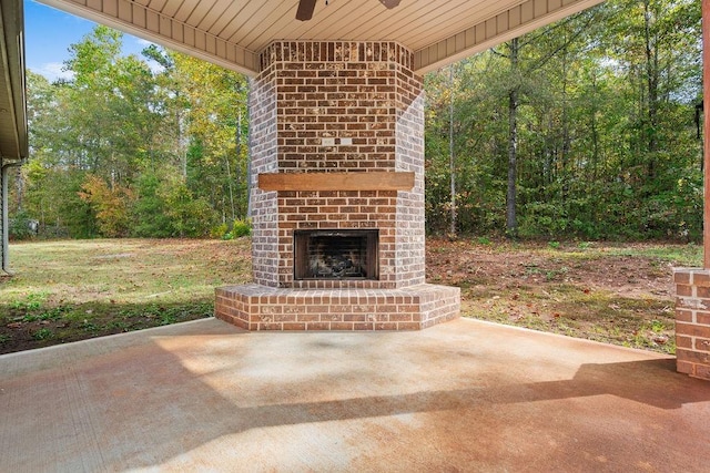 view of patio / terrace with ceiling fan and an outdoor brick fireplace