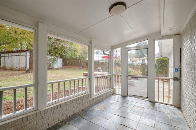 sunroom / solarium featuring lofted ceiling