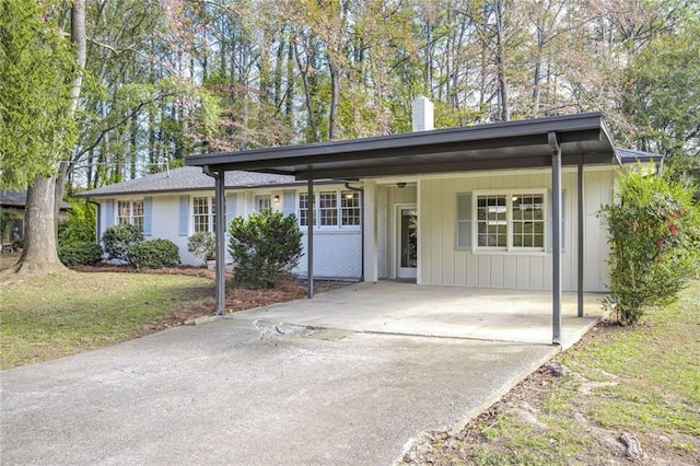 ranch-style house with a front lawn and a carport