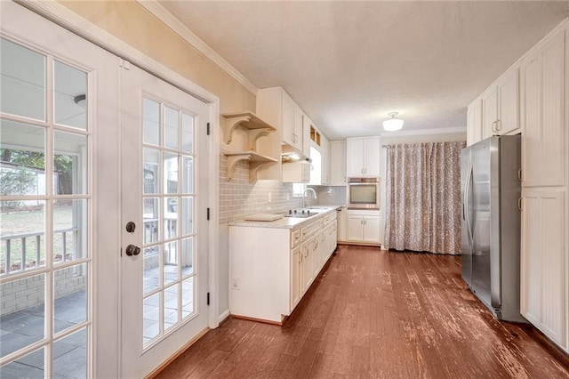 kitchen featuring a healthy amount of sunlight, white cabinetry, and appliances with stainless steel finishes