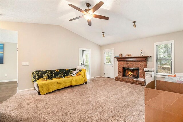 living area with carpet floors, a ceiling fan, and plenty of natural light