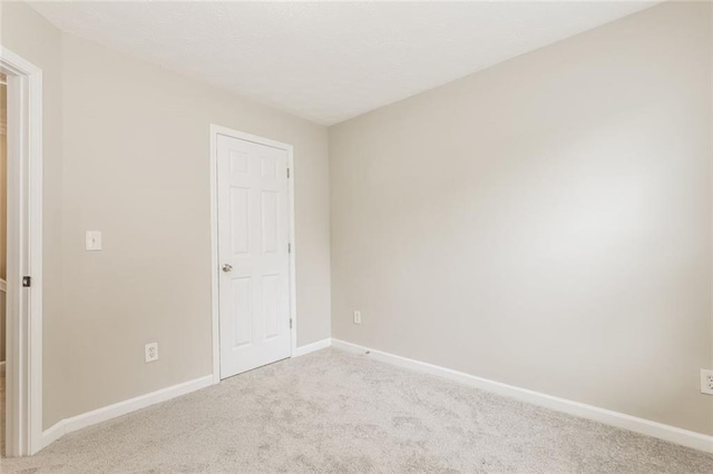 unfurnished bedroom featuring carpet and baseboards