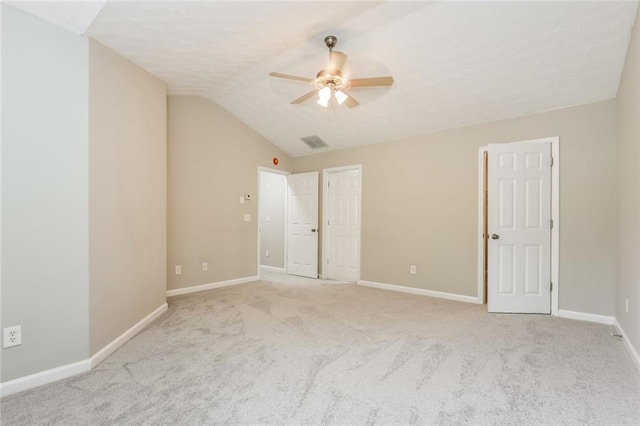 unfurnished bedroom with carpet, lofted ceiling, baseboards, and ceiling fan