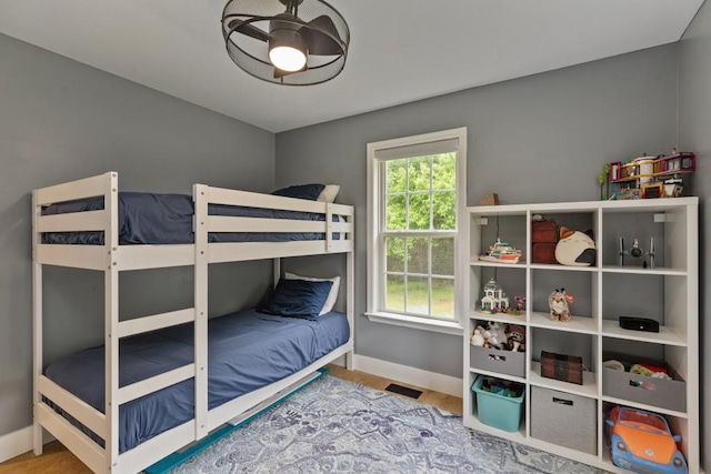 bedroom with baseboards and wood finished floors