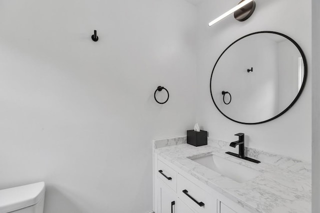 half bathroom featuring toilet and vanity