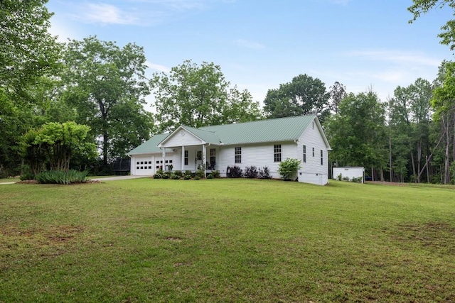 single story home featuring an attached garage, a front lawn, and metal roof