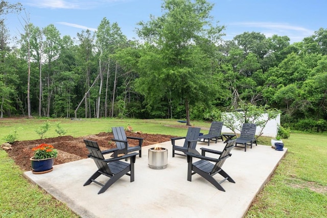 view of patio with an outdoor fire pit and an outbuilding