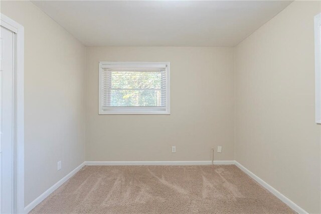 spare room with light colored carpet