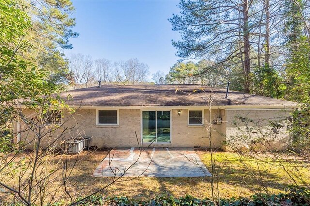 rear view of property with central AC unit and a patio