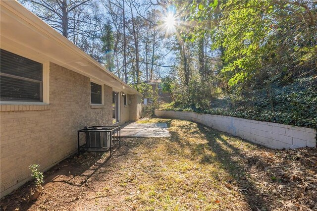 view of yard with a patio and central air condition unit