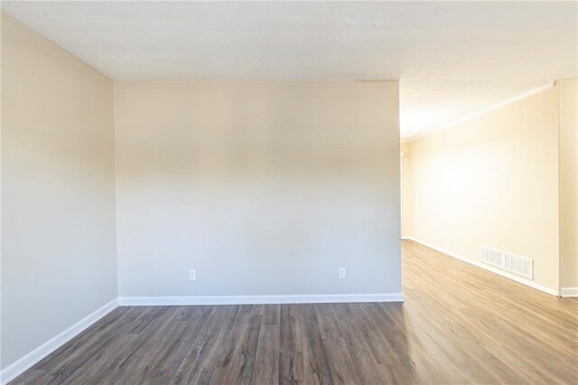 empty room featuring dark hardwood / wood-style flooring