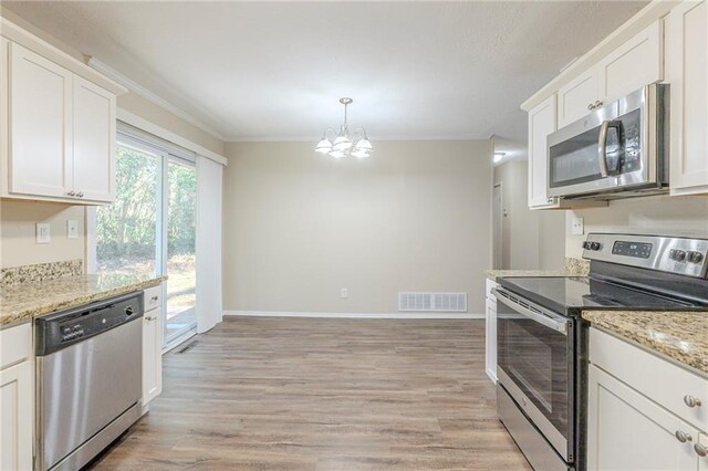 kitchen featuring a notable chandelier, crown molding, white cabinetry, stainless steel appliances, and light stone counters