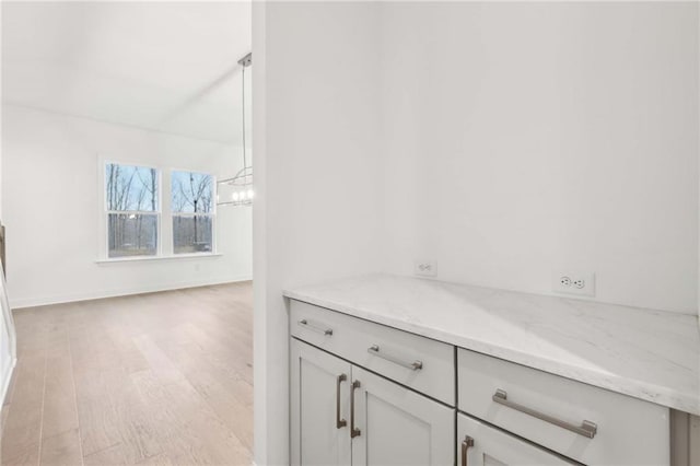 details featuring a chandelier and wood finished floors