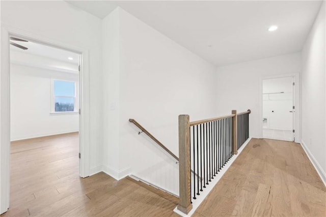 corridor featuring recessed lighting, an upstairs landing, baseboards, and wood finished floors