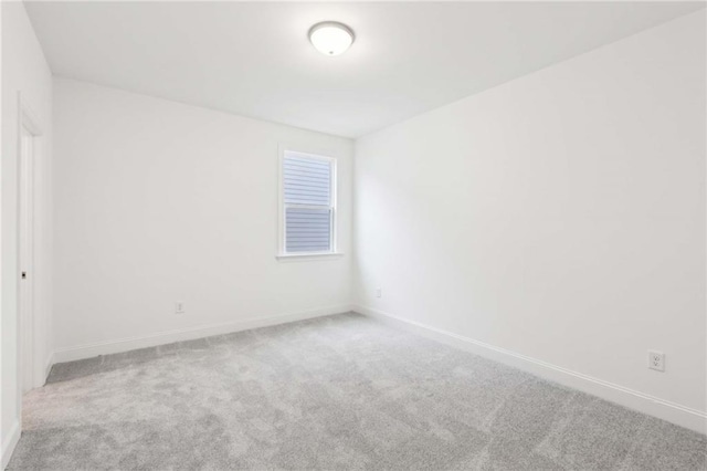 unfurnished room featuring baseboards and carpet