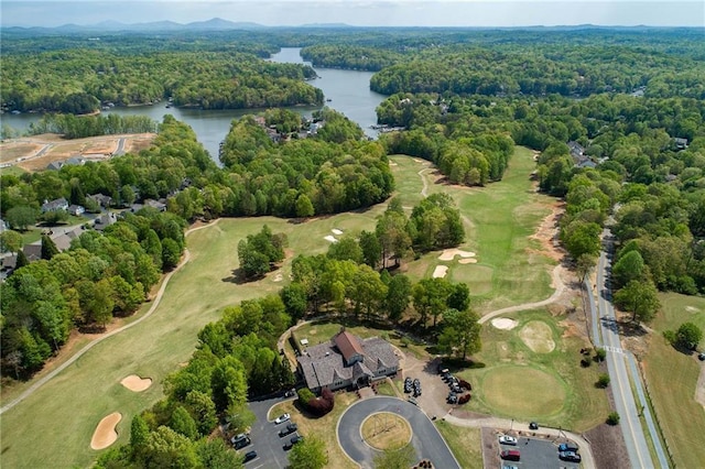 aerial view with a water view and a wooded view